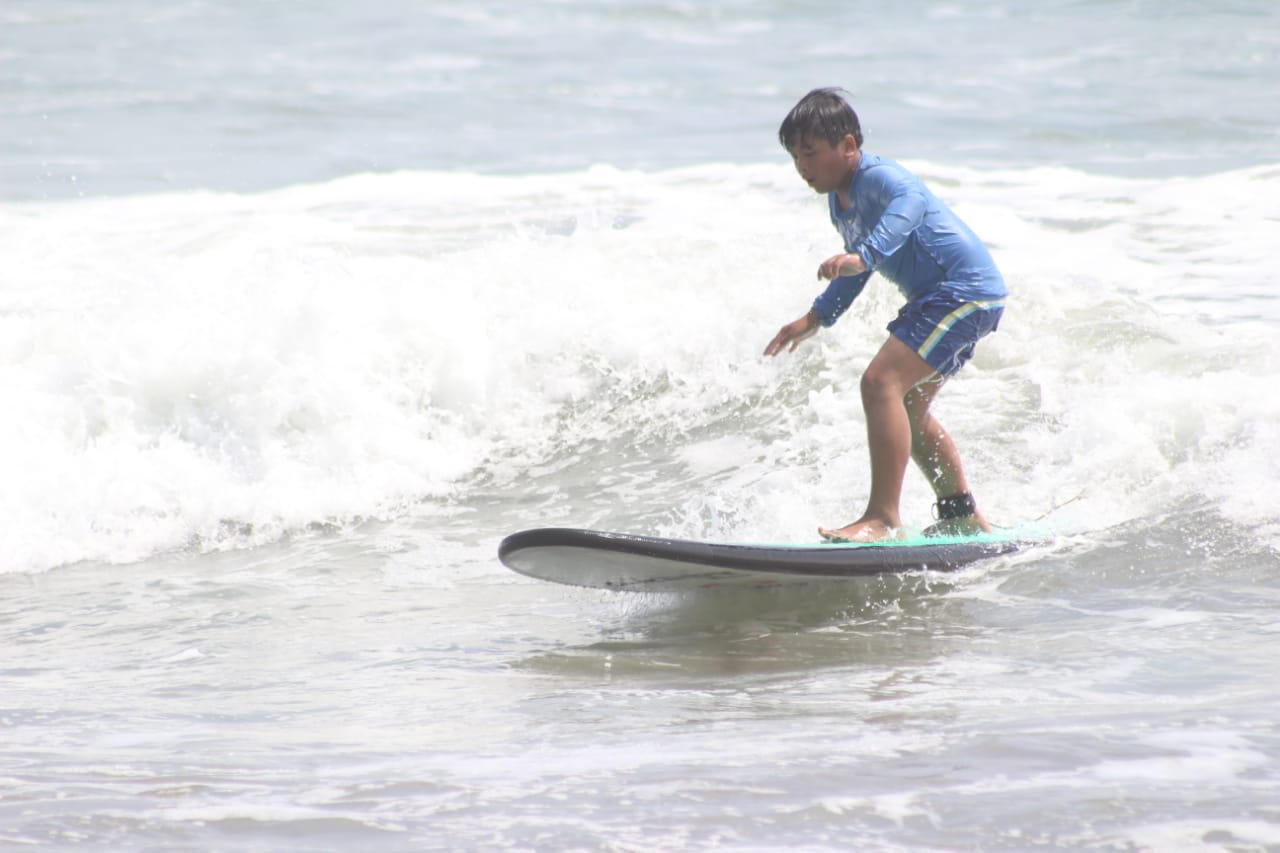 young boy surfing